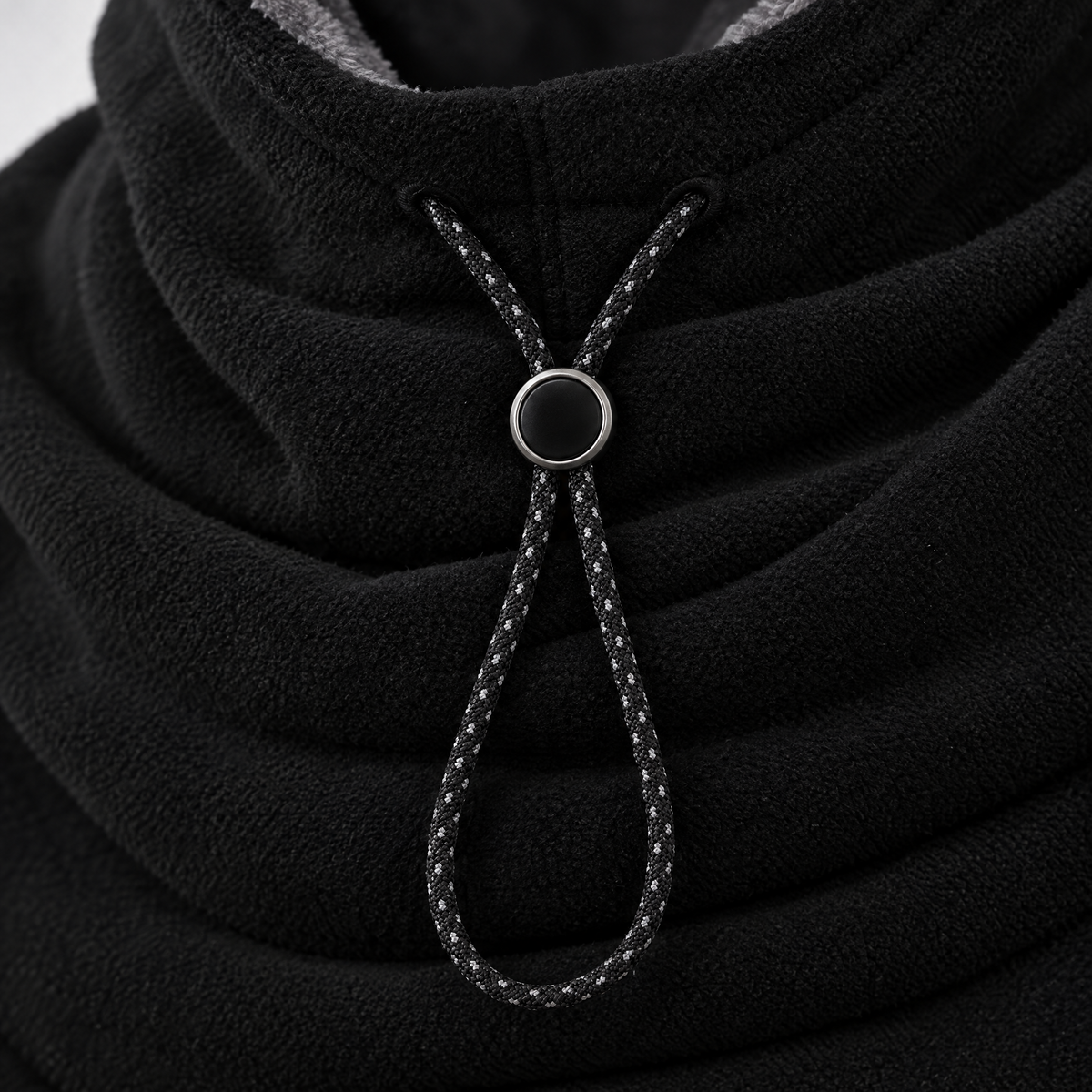 Close-up of the black hood drawcord and round toggle